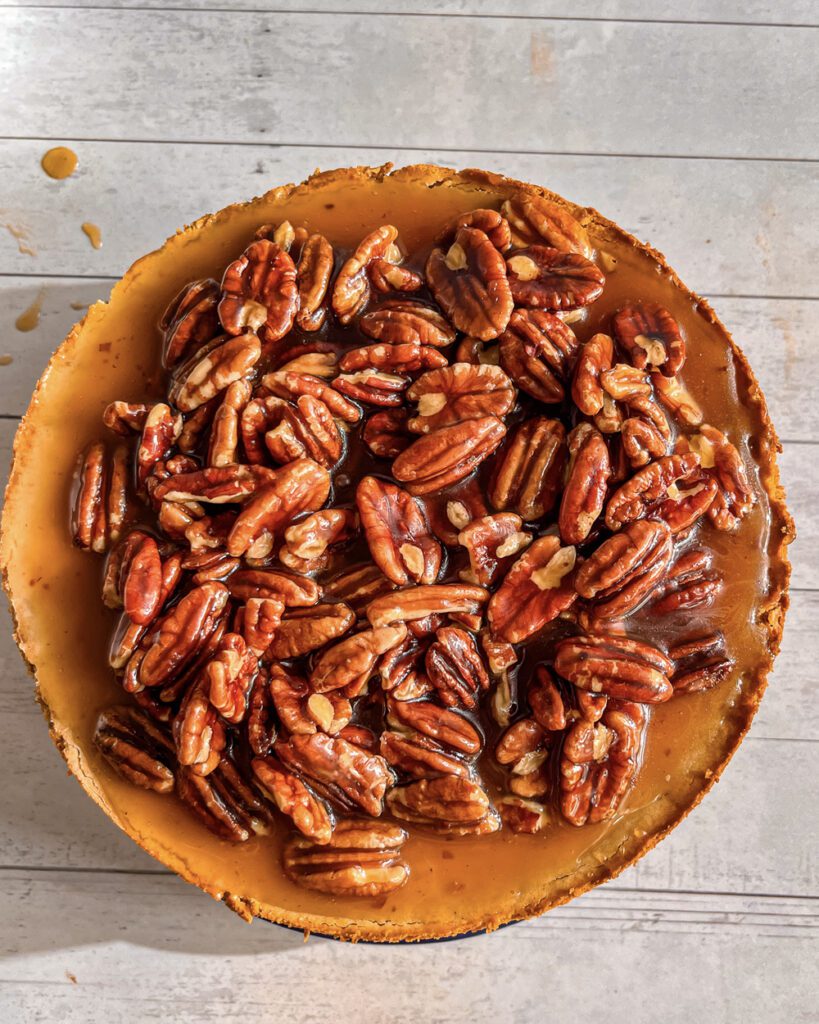 creamy eggless Caramel Pecan Cheesecake on a plate