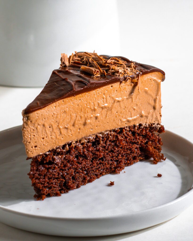 Eggless chocolate mousse cake with layers of moist chocolate sponge, airy mousse, and glossy ganache recipe