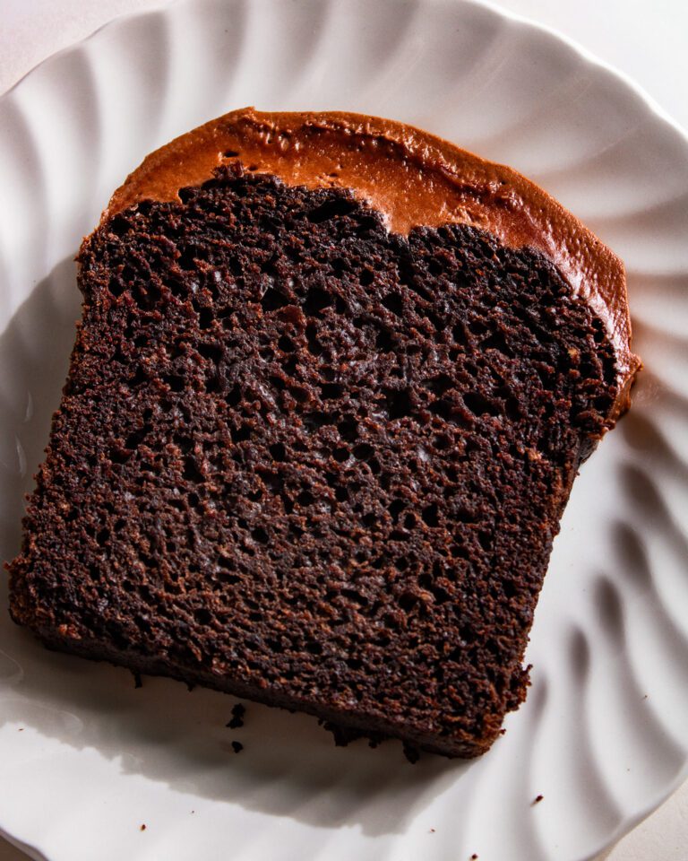 Recipe for Eggless chocolate loaf cake with cream cheese icing on a wooden board