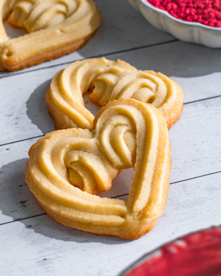 eggless Hand-piping butter cookie dough into heart shapes