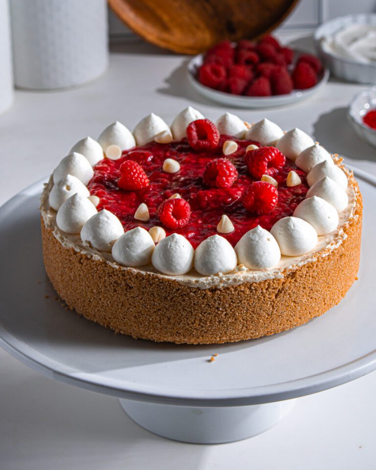Eggless white chocolate cheesecake topped with fresh raspberry