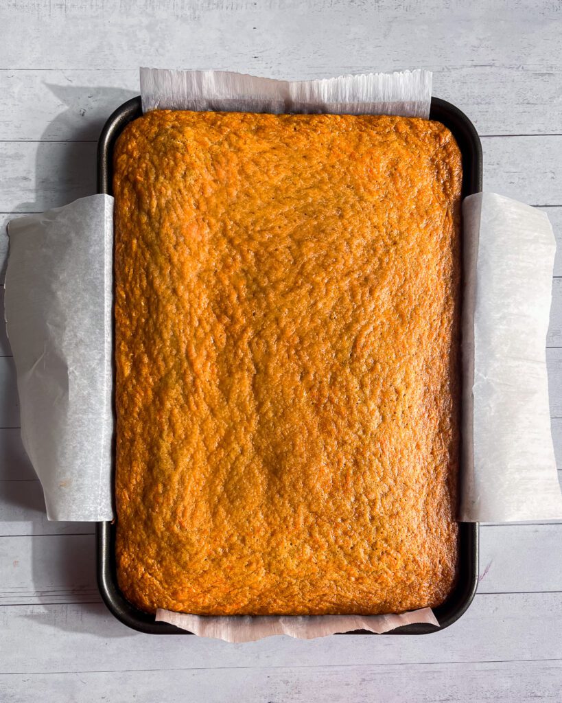 freshly baked carrot sheet cake cooling in pan