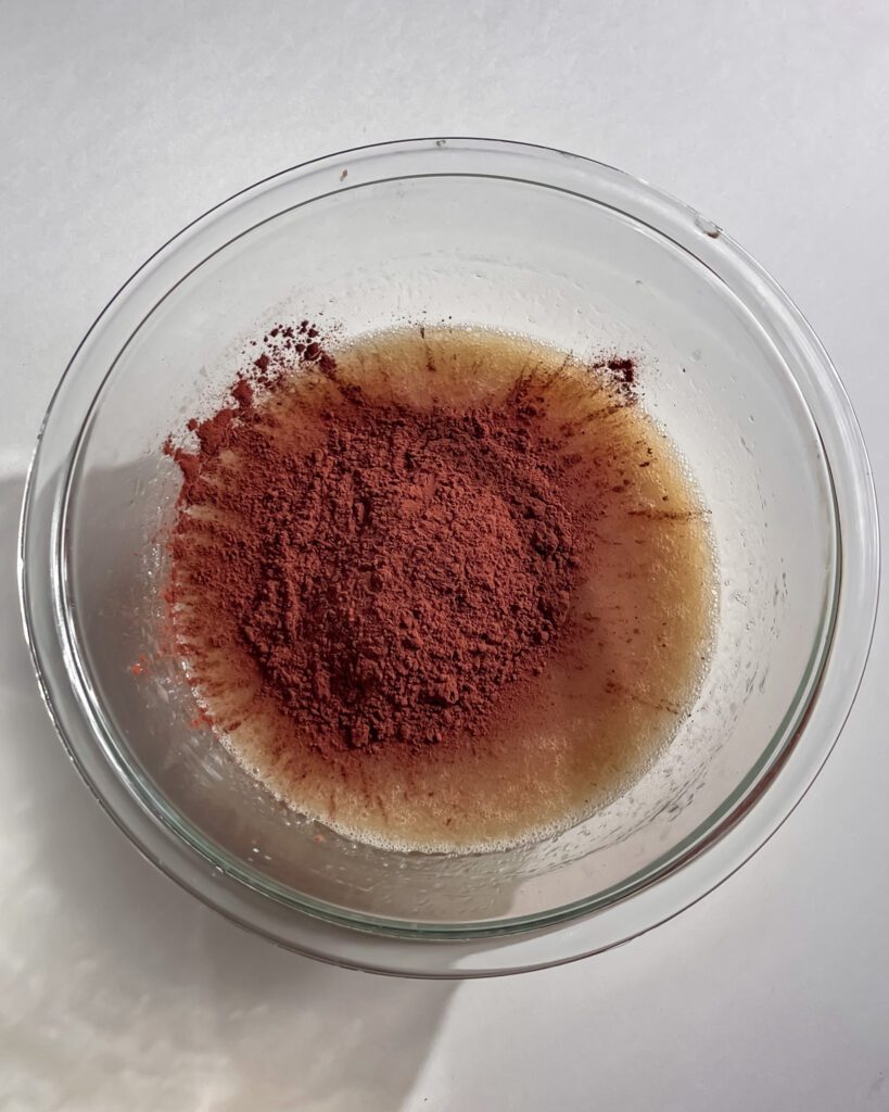 Adding cocoa powder into chocolate cake batter