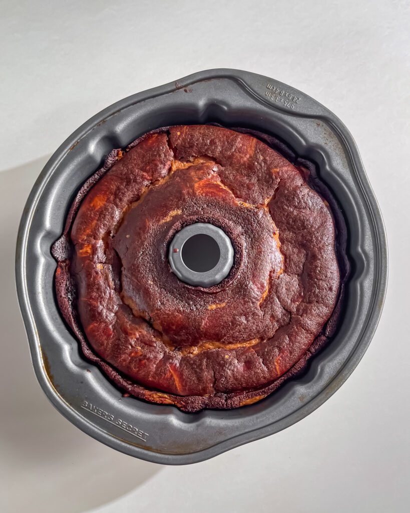 Freshly baked chocolate bundt cake cooling in pan