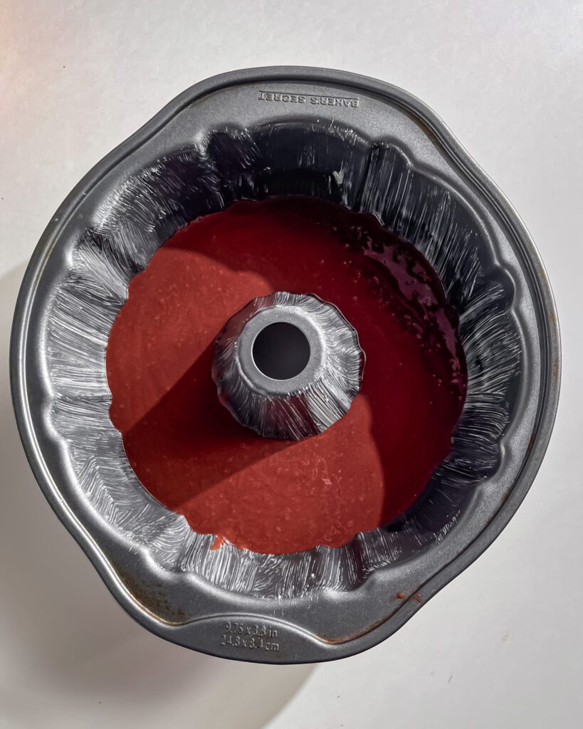 Pouring chocolate batter into greased bundt pan