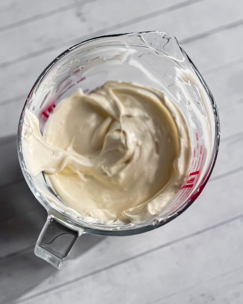 Preparing coffee cream cheese filling in mixing bowl