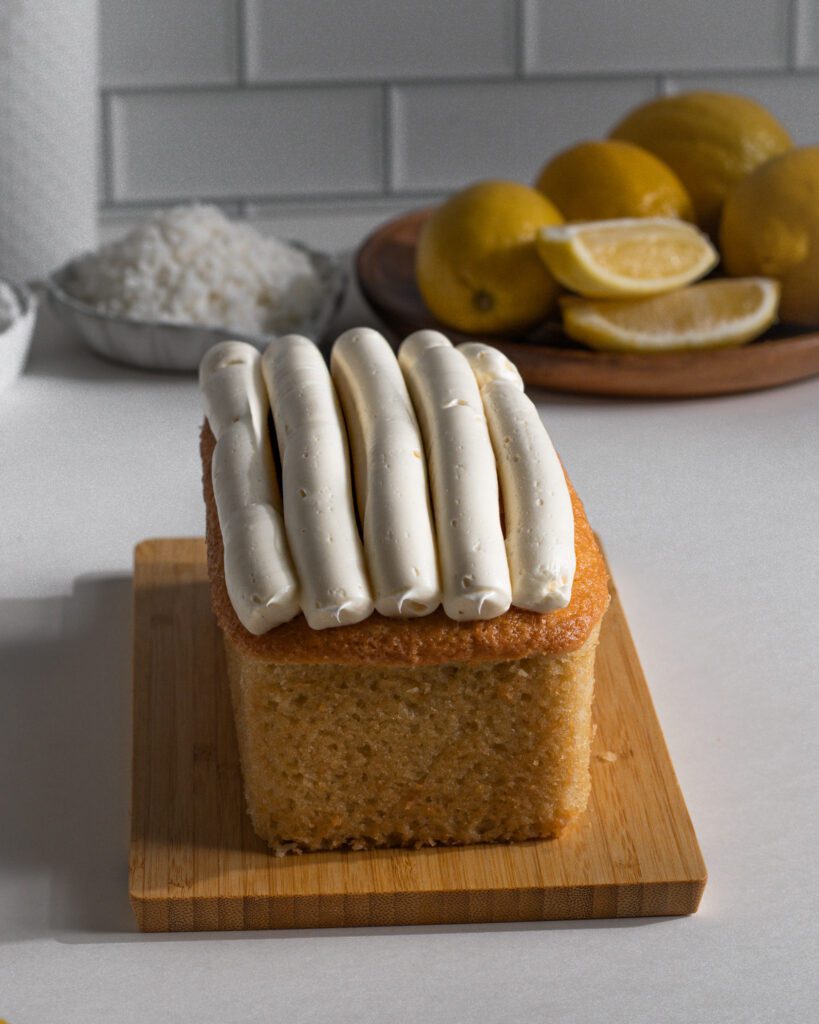 smooth cream cheese frosting over cooled loaf cake